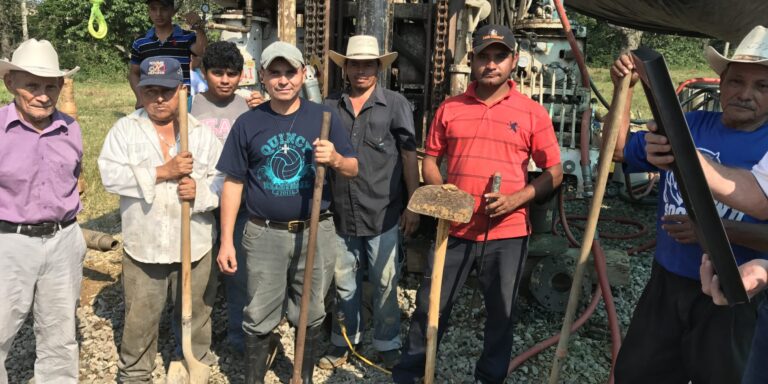 Residents from the community work along side the Mountain of Hope team to get water